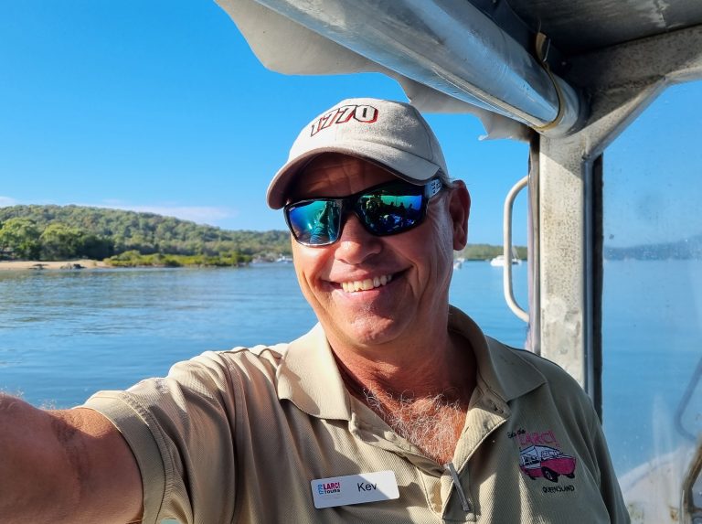 Photo of LARC Tour Guide on the LARC with the ocean in the background.