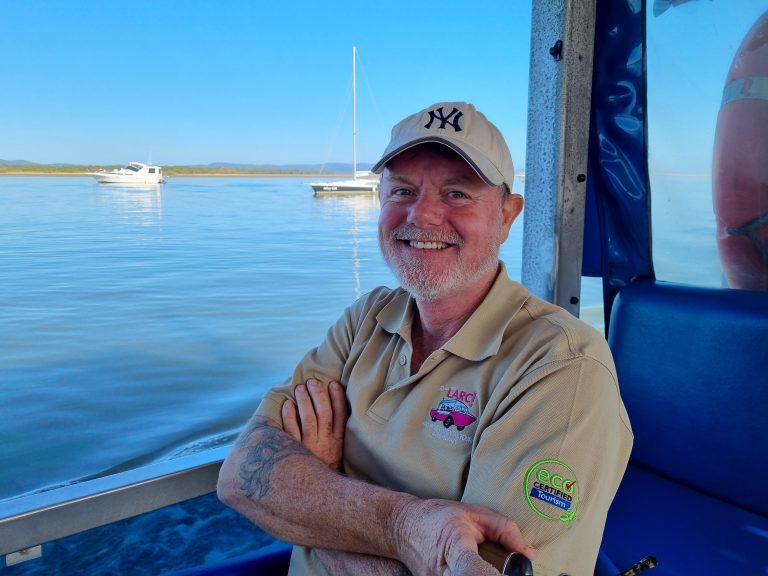 LARC skipper sitting on the LARC with the ocean in the background.